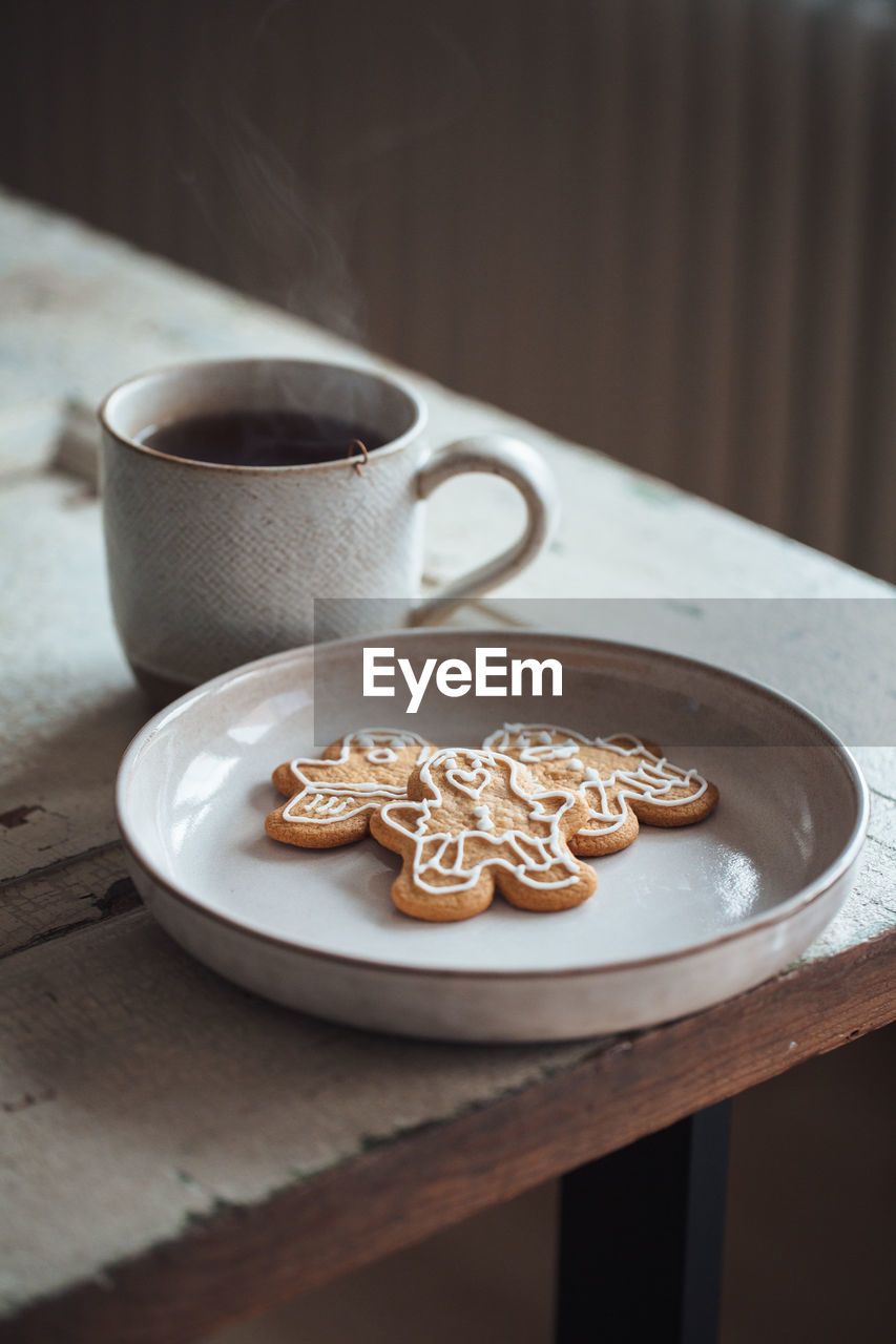 High angle view of cup of tea and biscuits on table