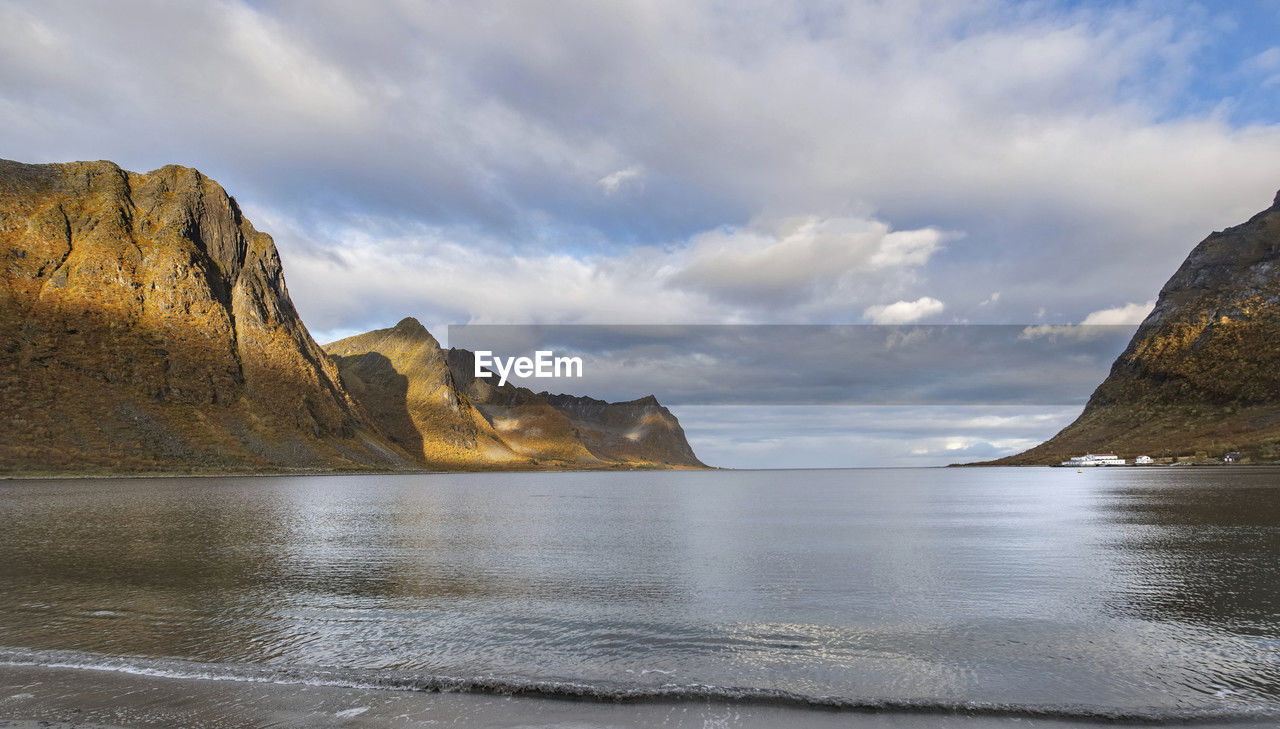 View from the beach on large mountains in a fjork at skaland in the senja island in norway
