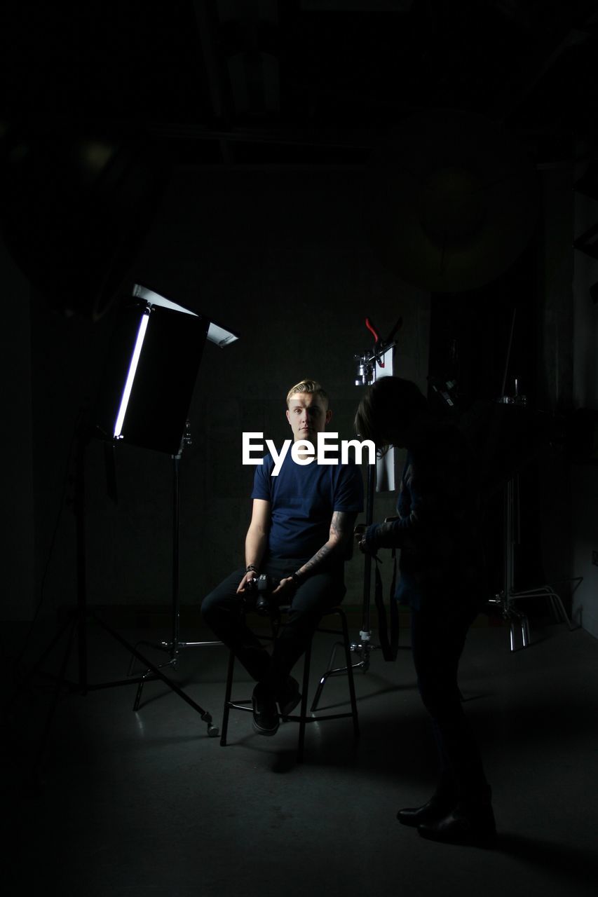 Portrait of man sitting in studio