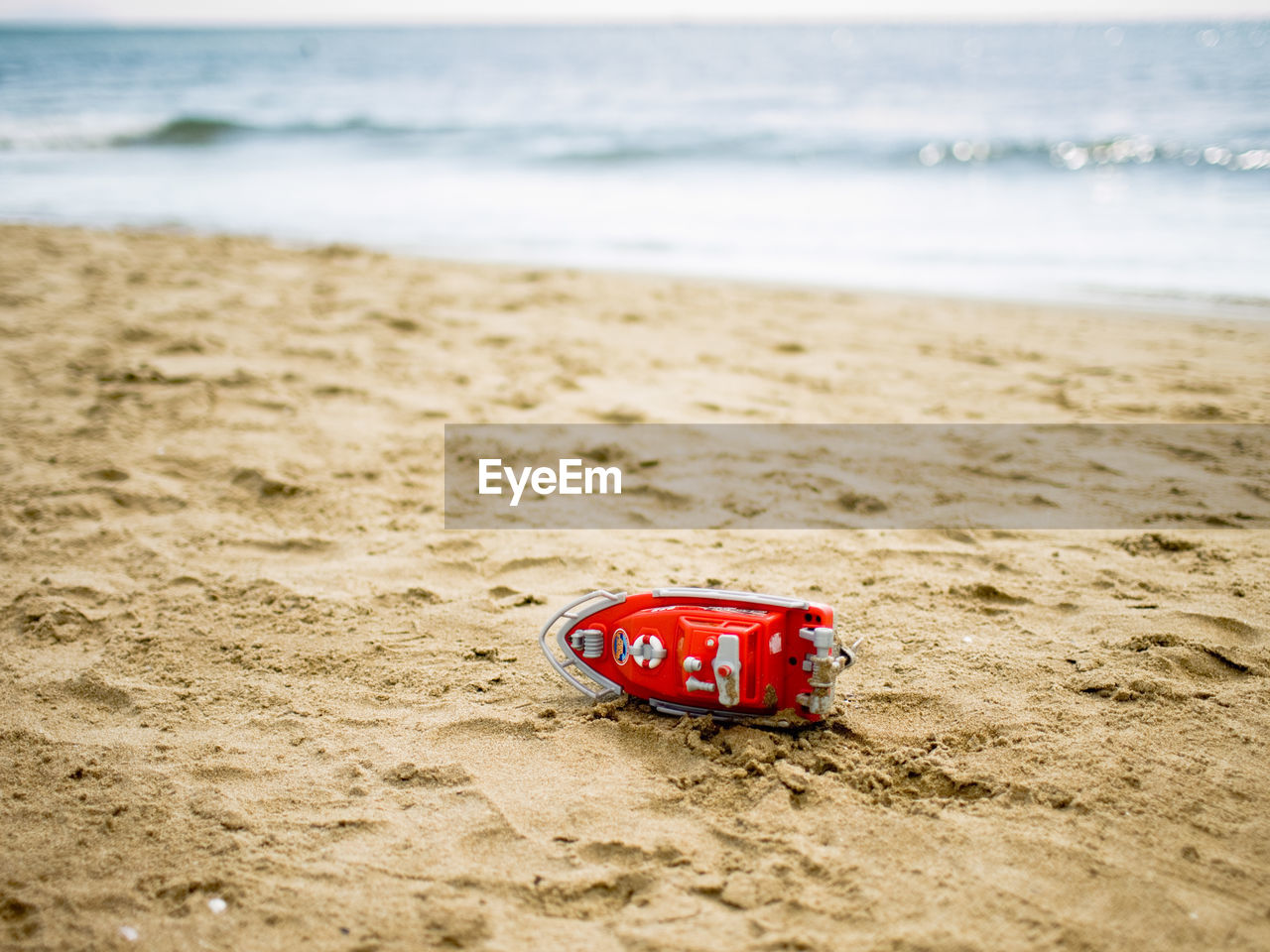 CLOSE-UP OF RED SIGN ON BEACH