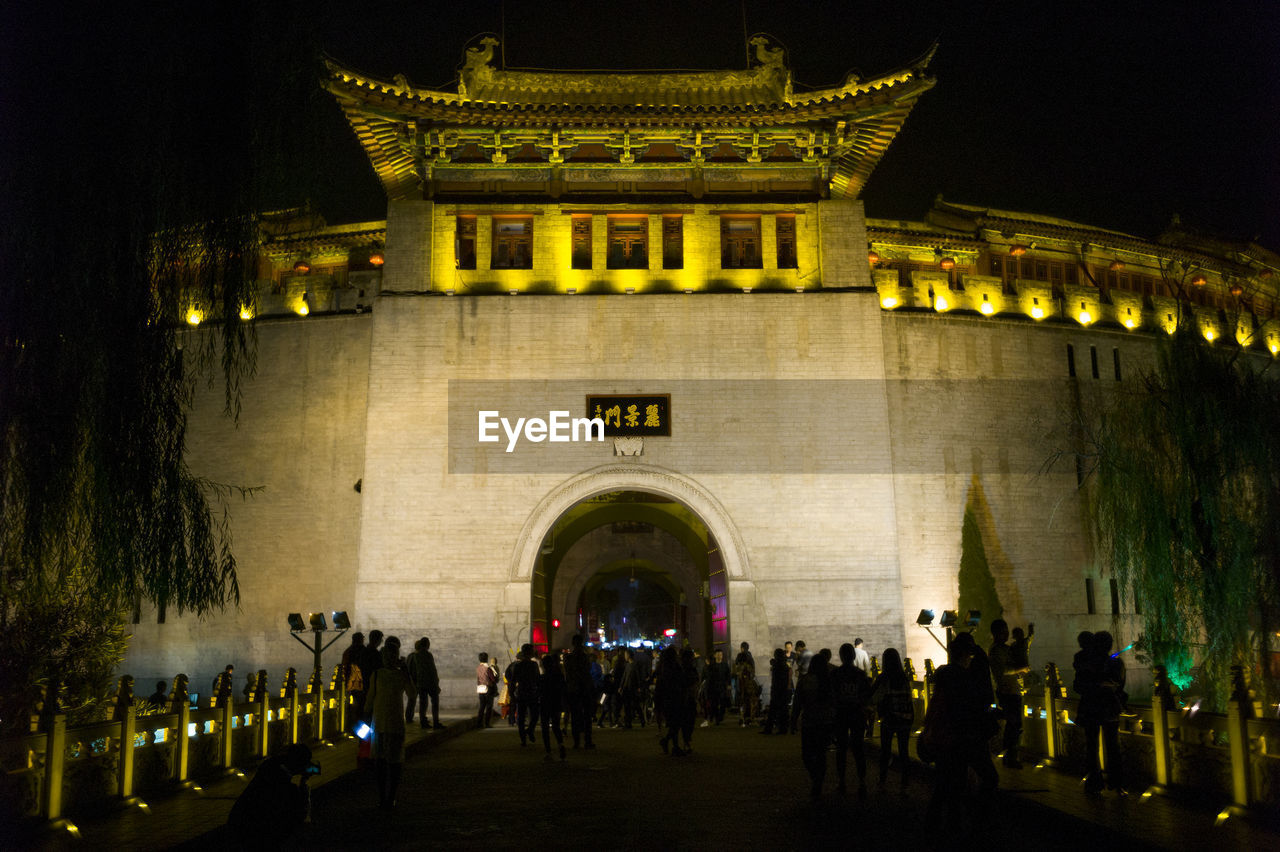 PEOPLE AT ILLUMINATED HISTORICAL BUILDING