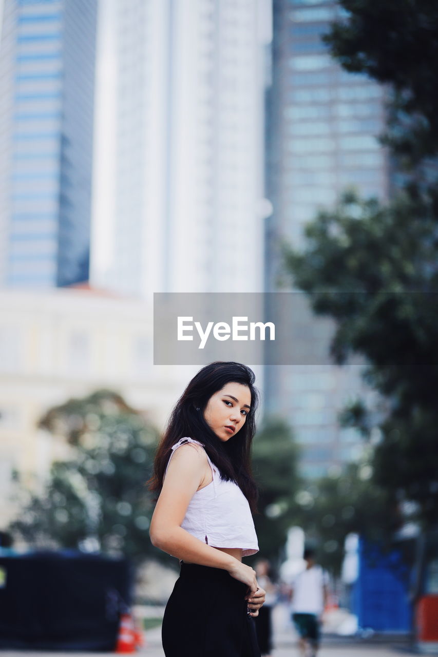 Portrait of woman standing in city