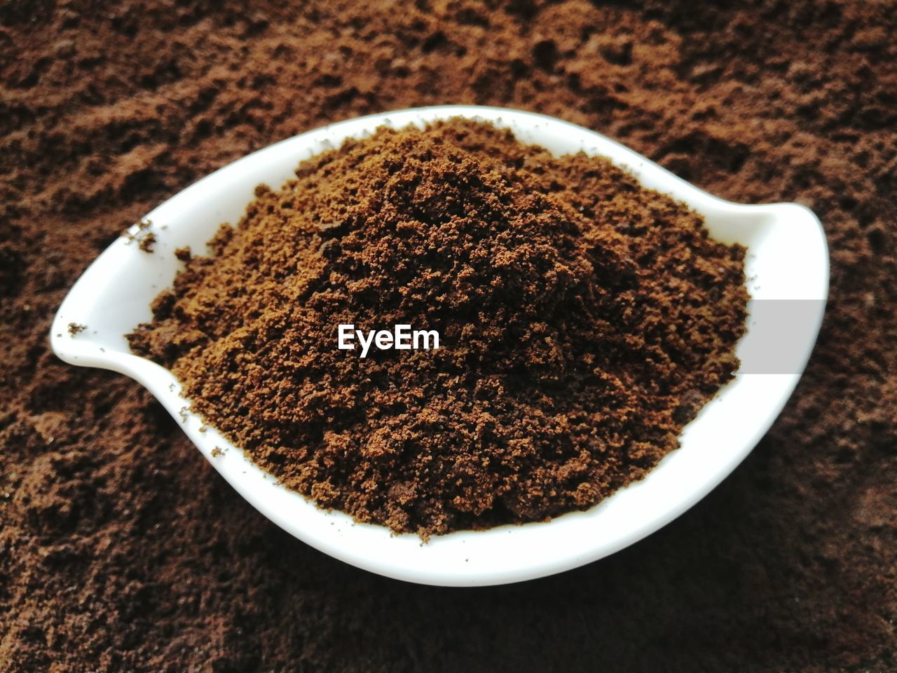 Coffee grounds on white ceramic bowl