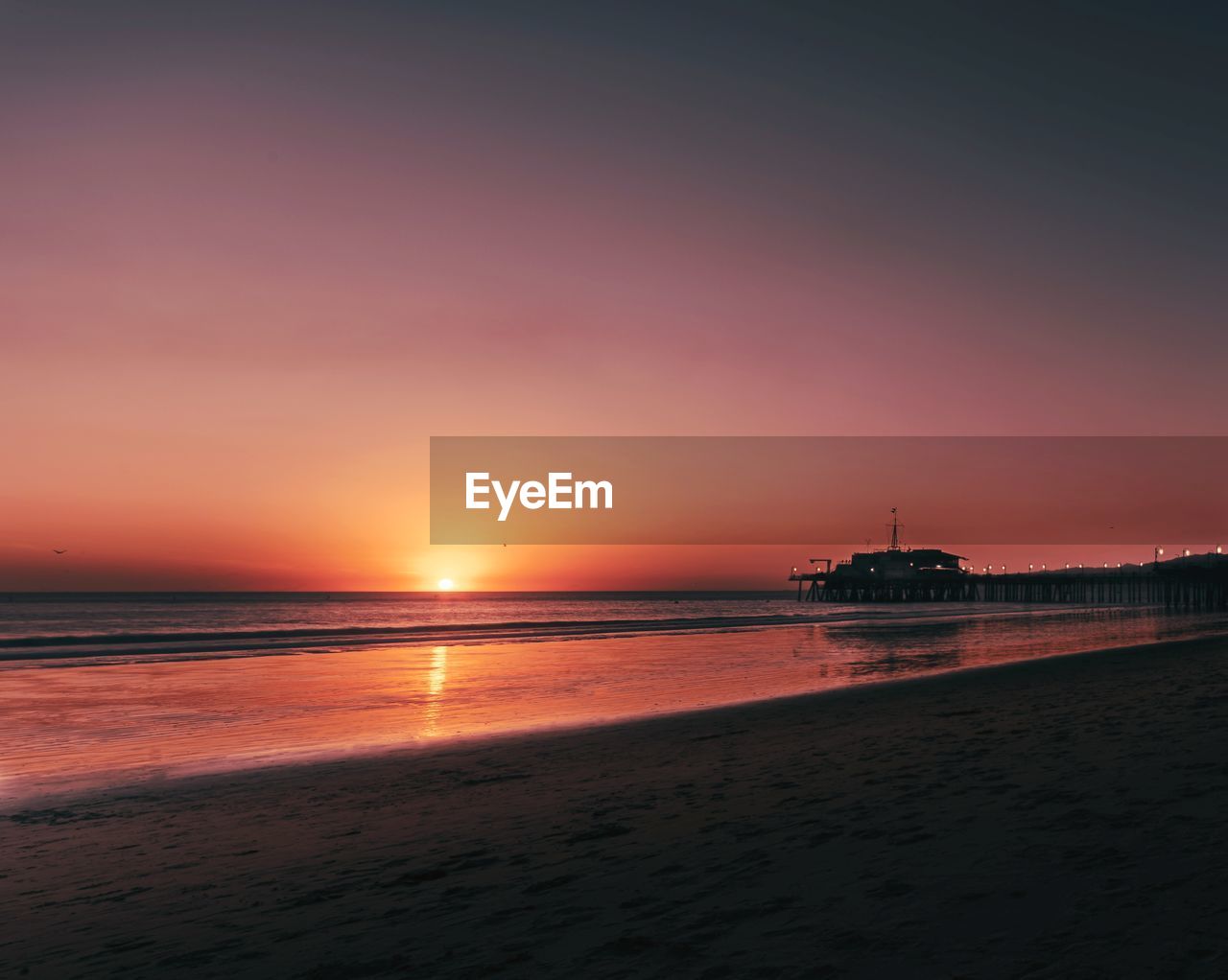 SCENIC VIEW OF BEACH DURING SUNSET