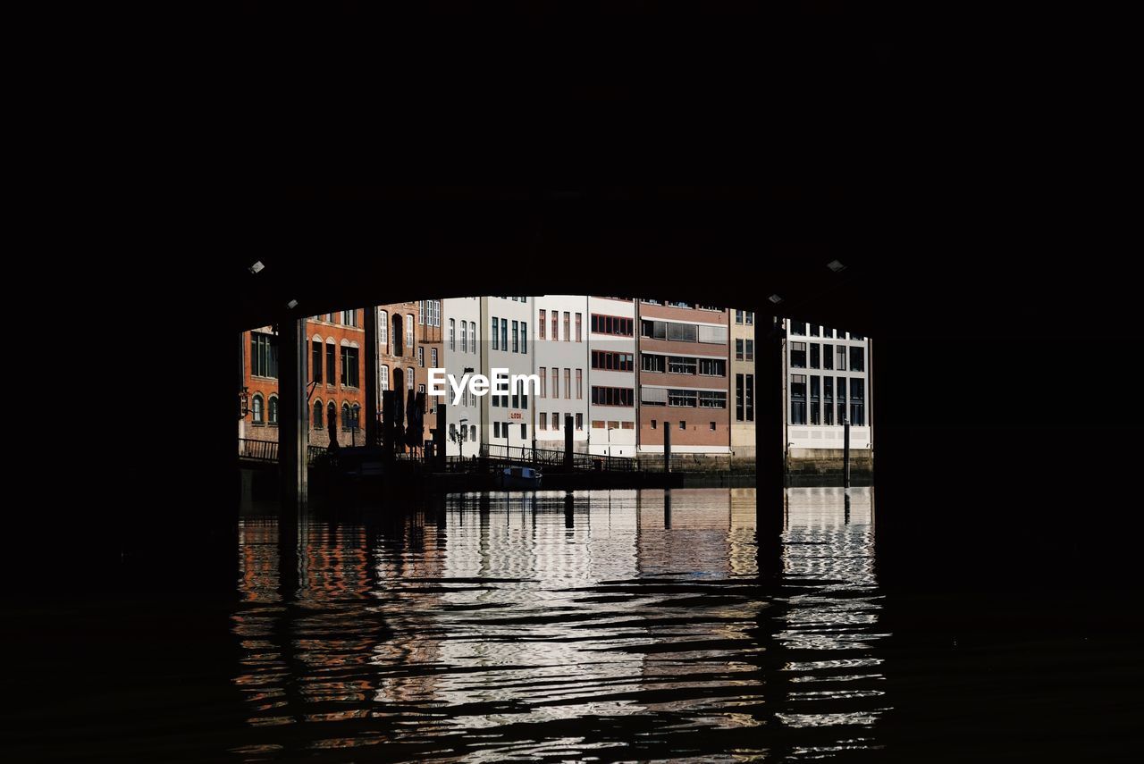 Reflection of building in lake at night