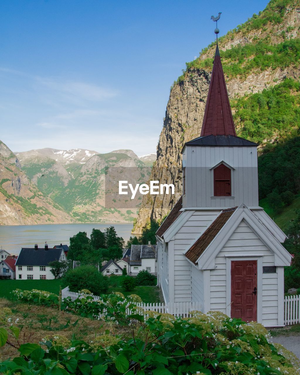 CHURCH BY BUILDING AGAINST SKY