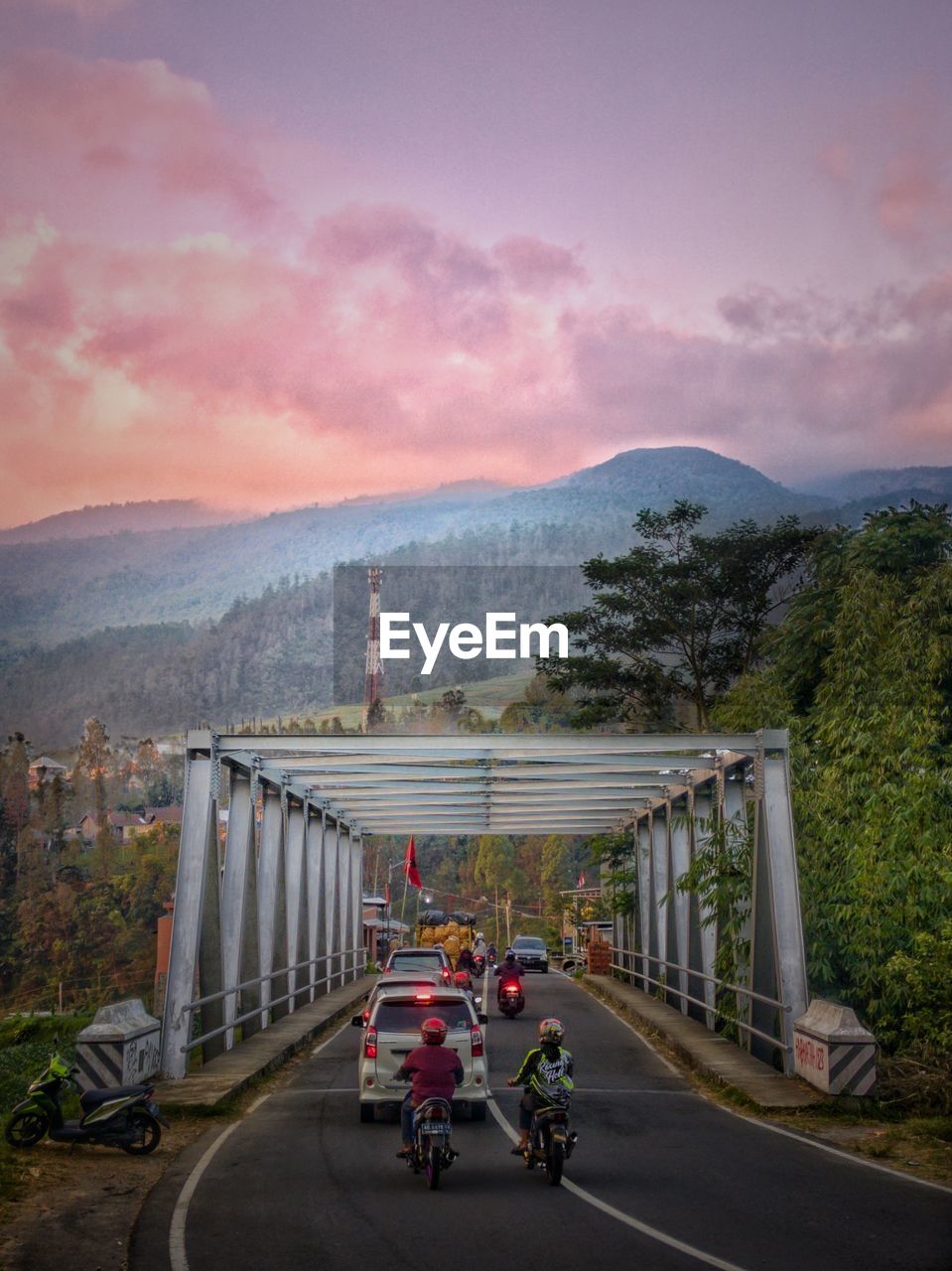 One of some bridges in tawangmangu, indonesia with lawu mountain covered by clouds as a background