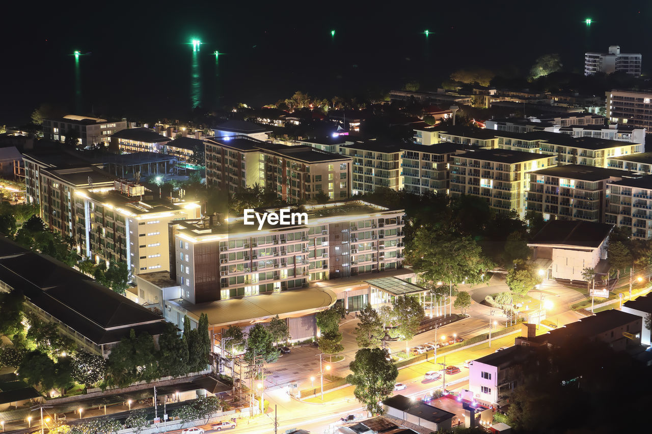 HIGH ANGLE VIEW OF ILLUMINATED BUILDINGS IN CITY