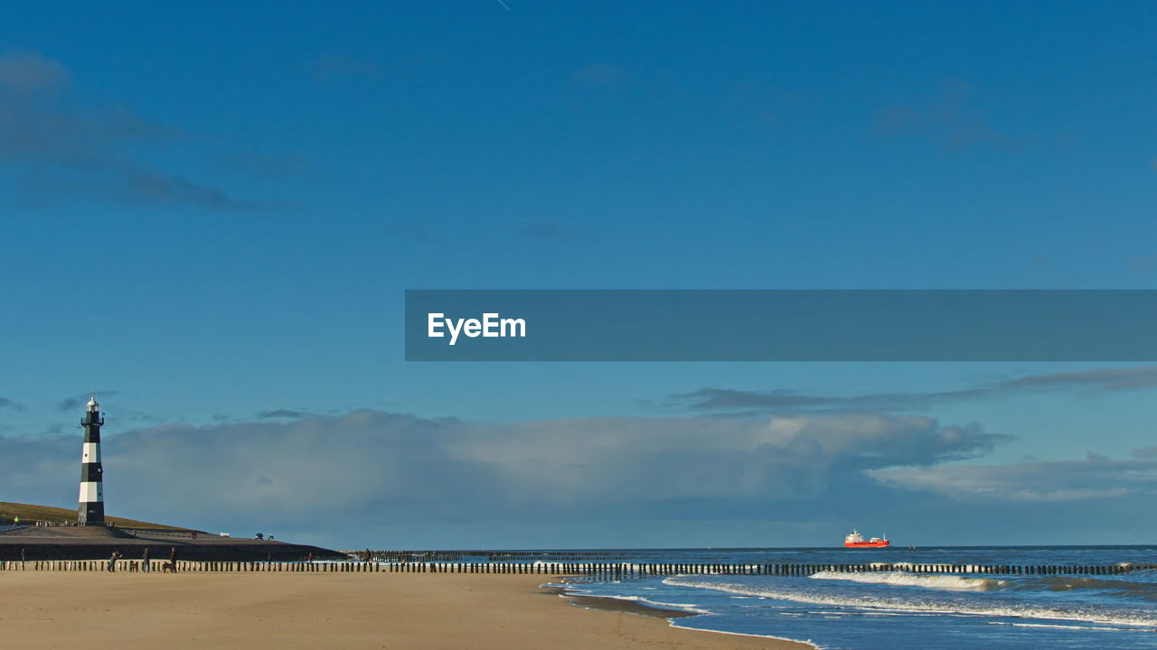 Scenic view of beach against blue sky