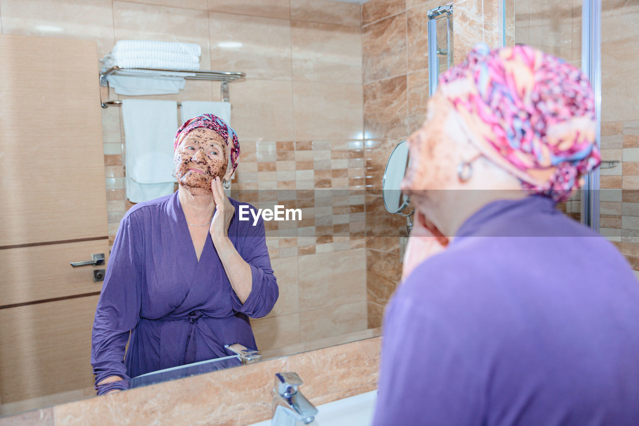 Elderly woman taking care of her face