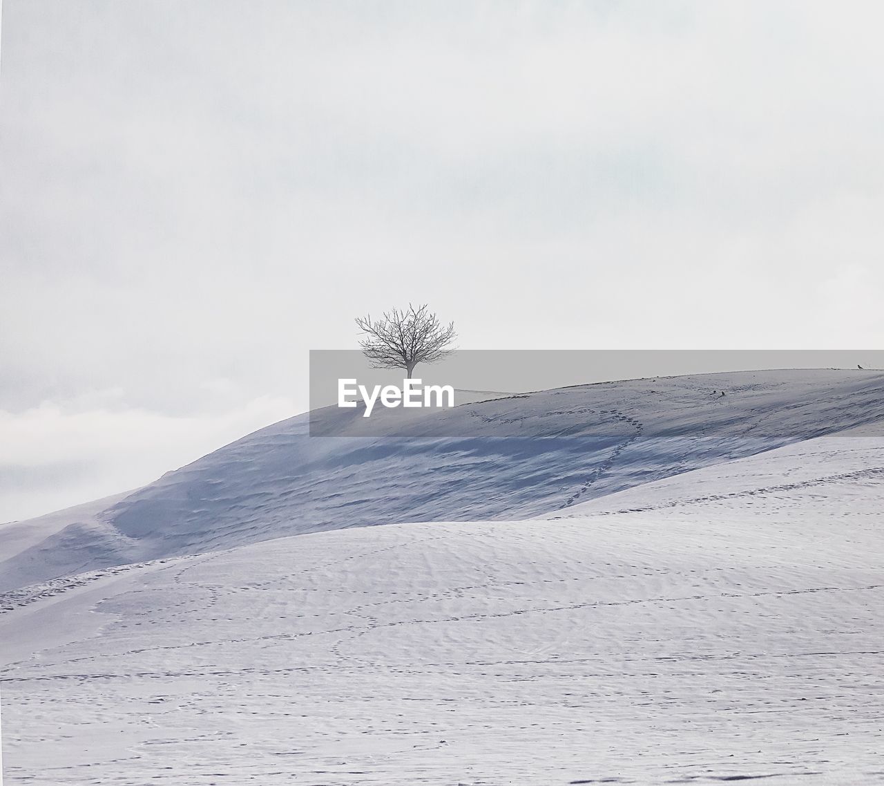 VIEW OF SNOW COVERED LAND AGAINST SKY