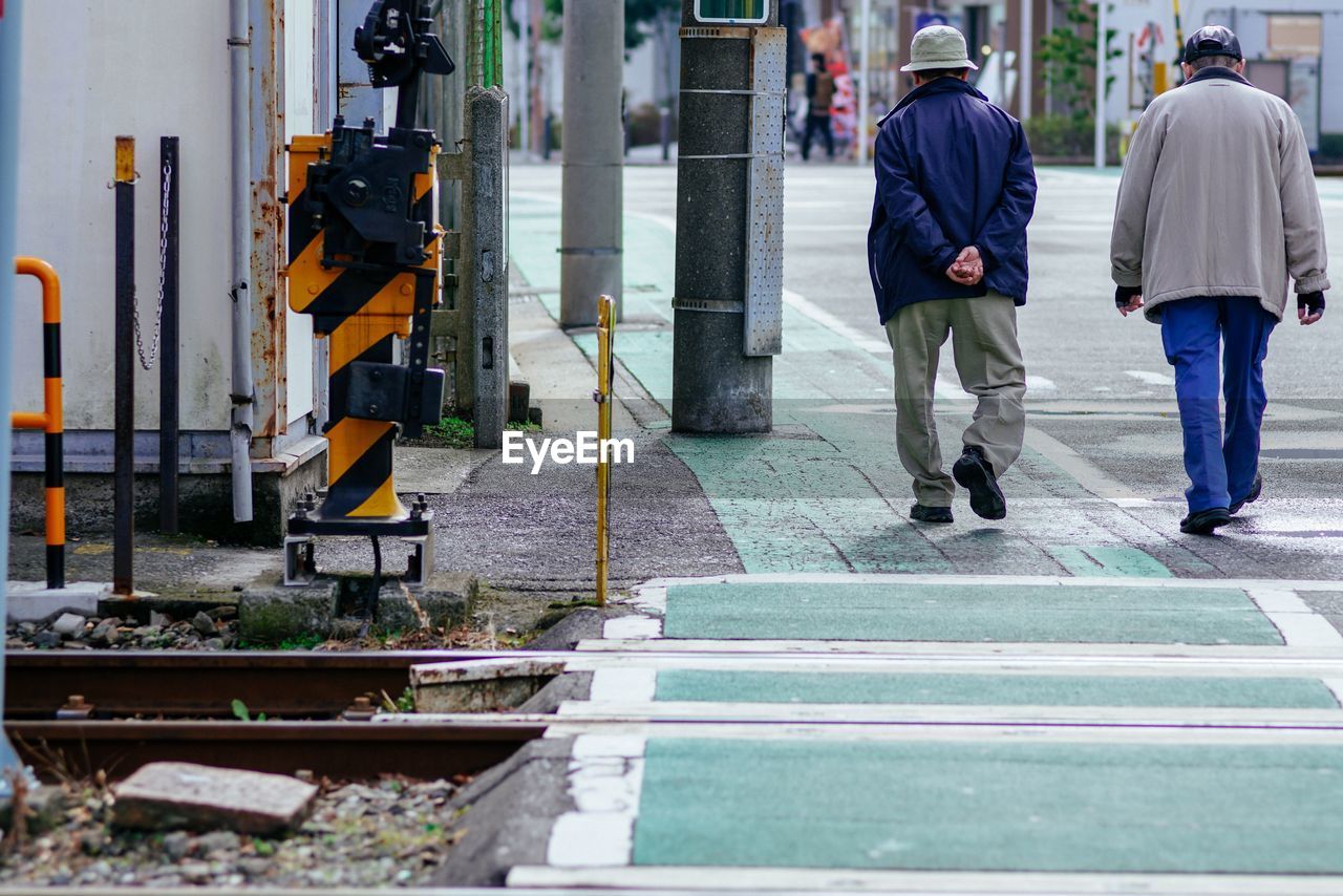 MEN WALKING ON STREET