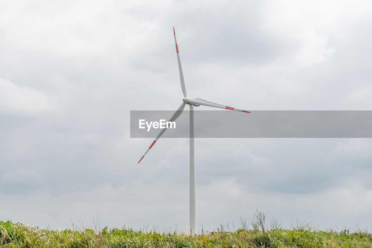 low angle view of windmill against cloudy sky