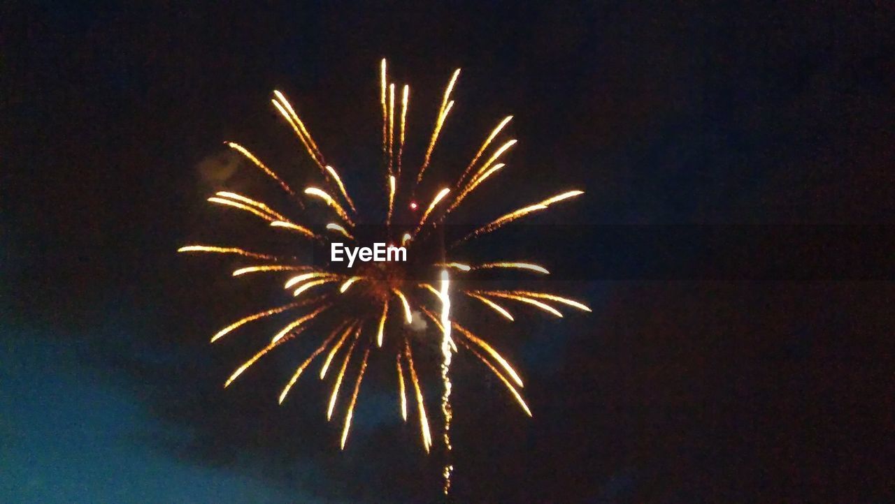 Low angle view of firework display at night