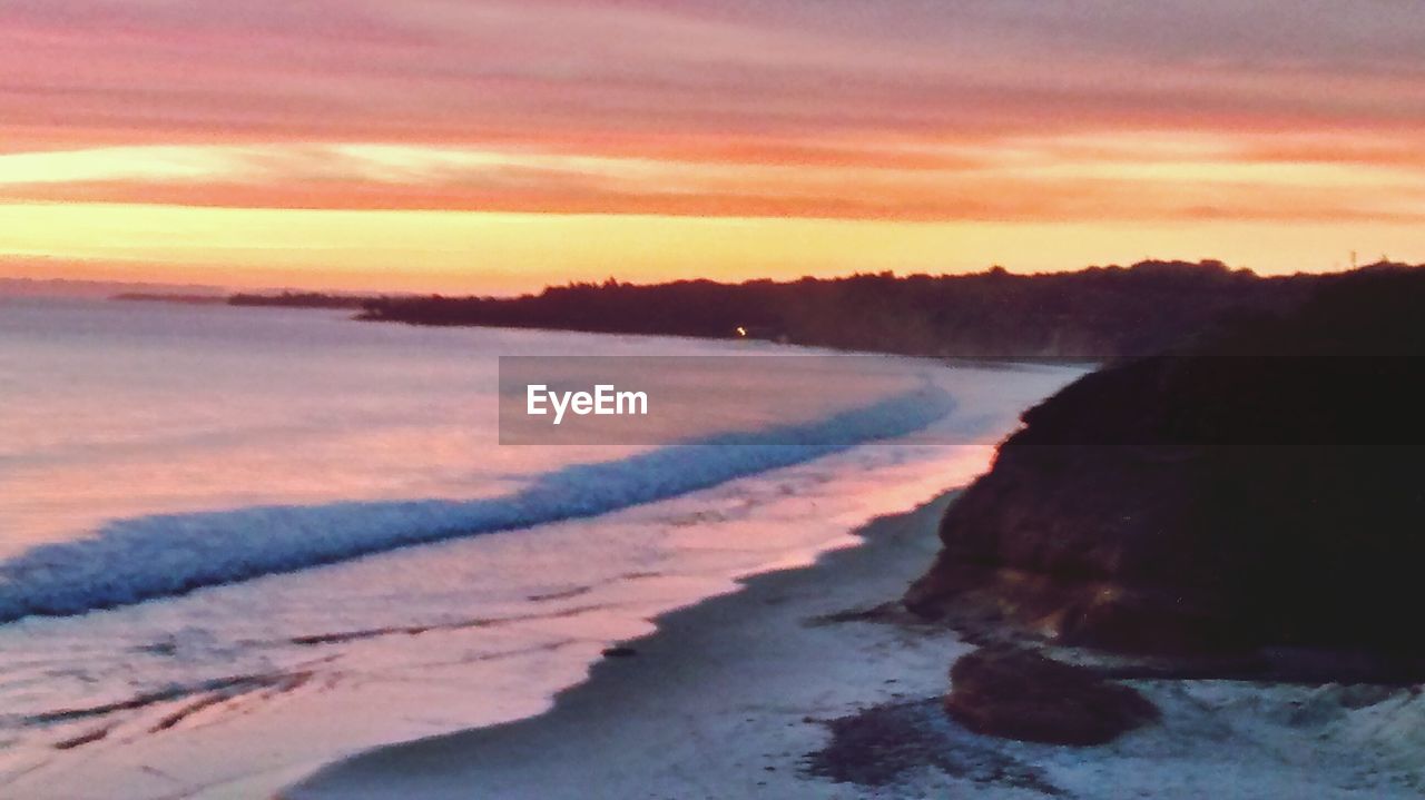 Scenic view of sea against sky at sunset