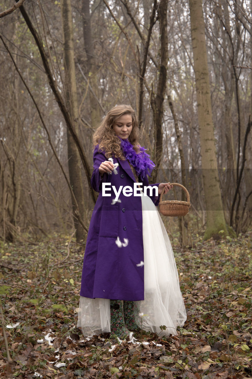 Woman standing in forest