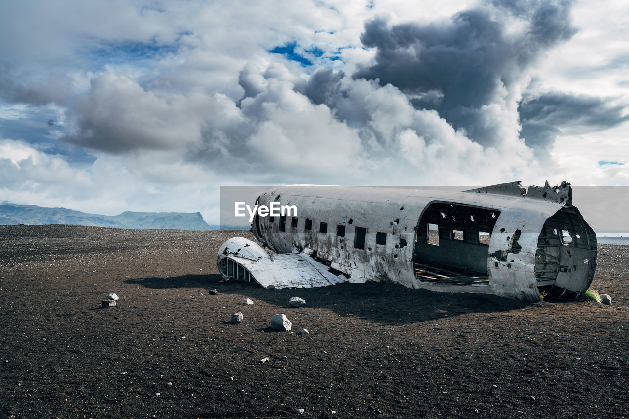 Airplane on runway against sky