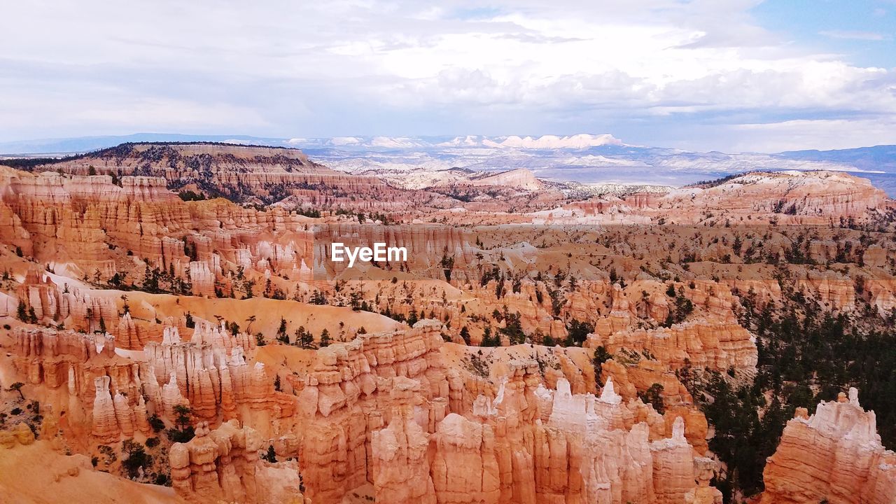 Rock formations against cloudy sky