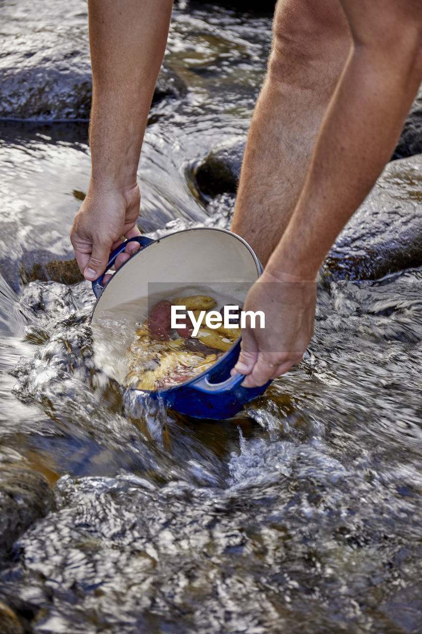 Filling pot with water to cook potatoes