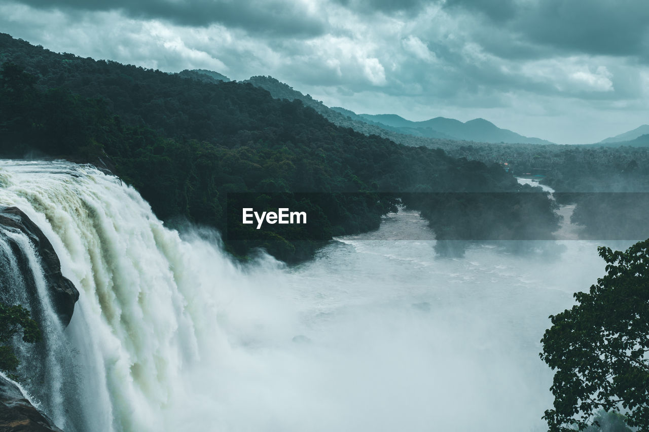 Scenic view of waterfall against sky