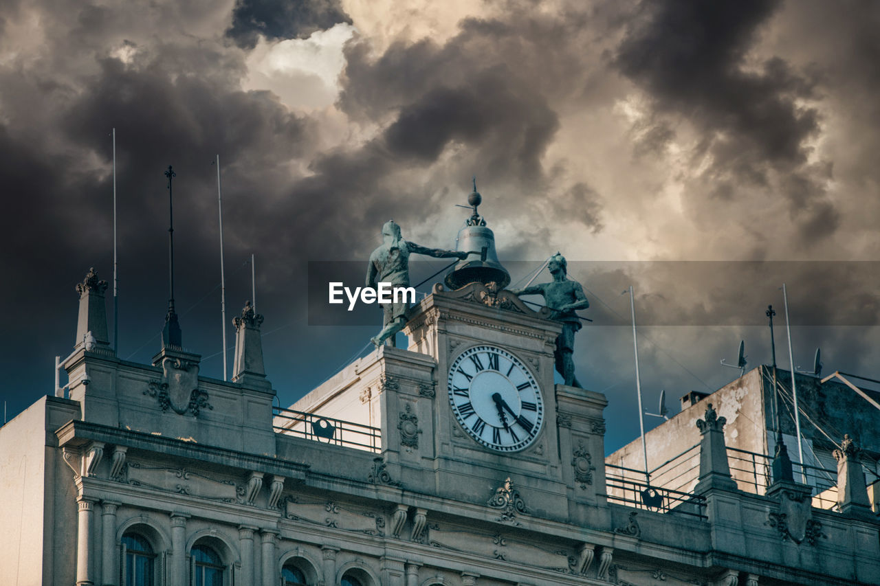 Low angle view of clock tower against sky