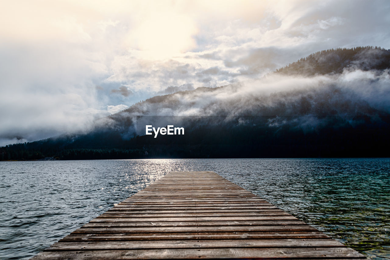 Pier over lake against sky