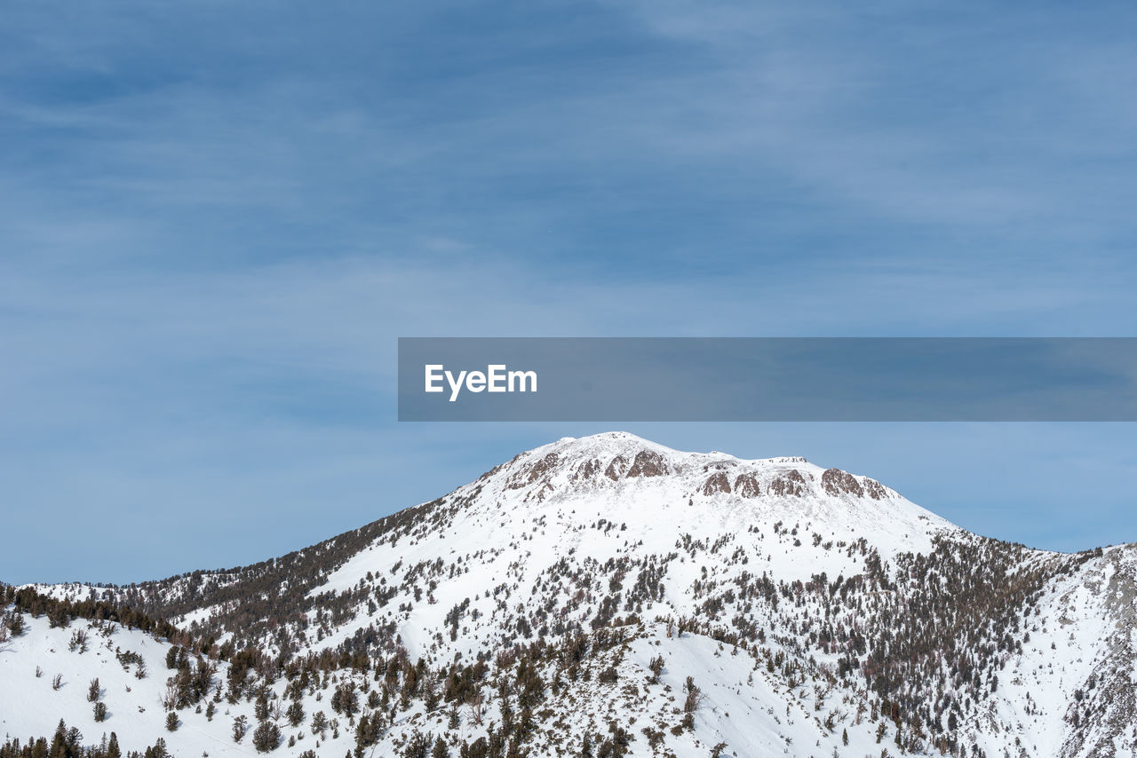 Scenic view of snow covered mountains against sky