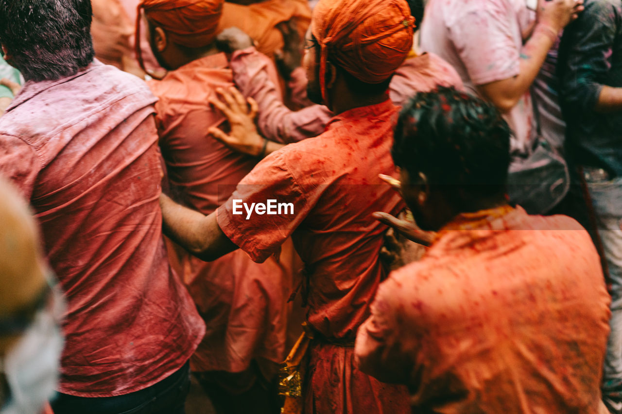 Men playing holi in city