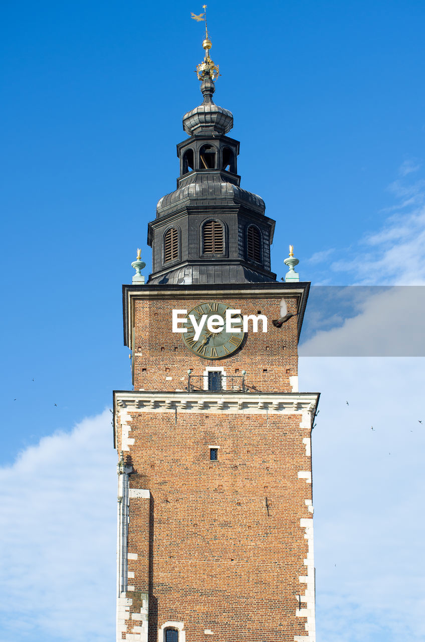 Low angle view of bell tower against blue sky