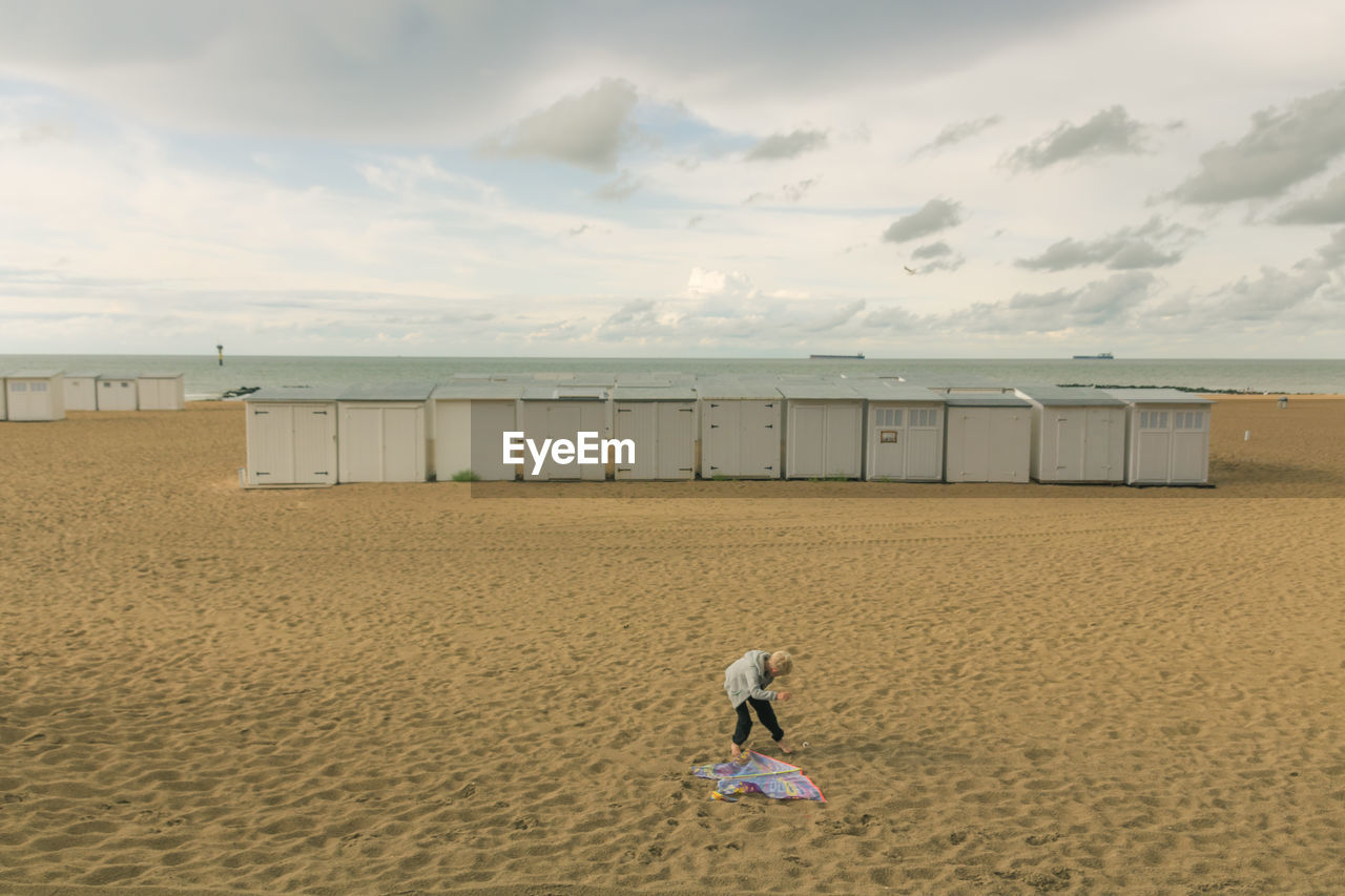 REAR VIEW OF BOY ON BEACH