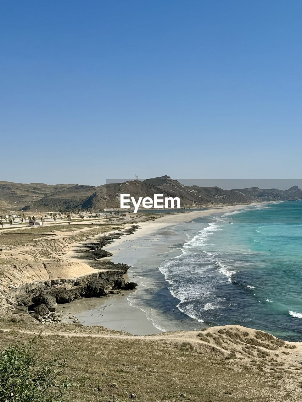 scenic view of beach against clear sky
