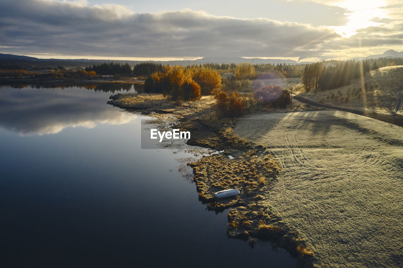 Lake and coast during sunset in autumn countryside