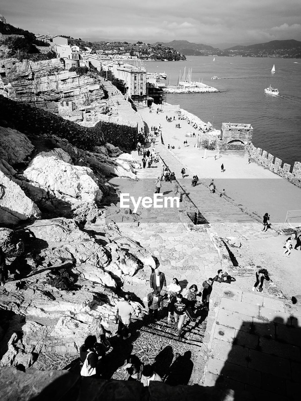 HIGH ANGLE VIEW OF PEOPLE AT SEASIDE