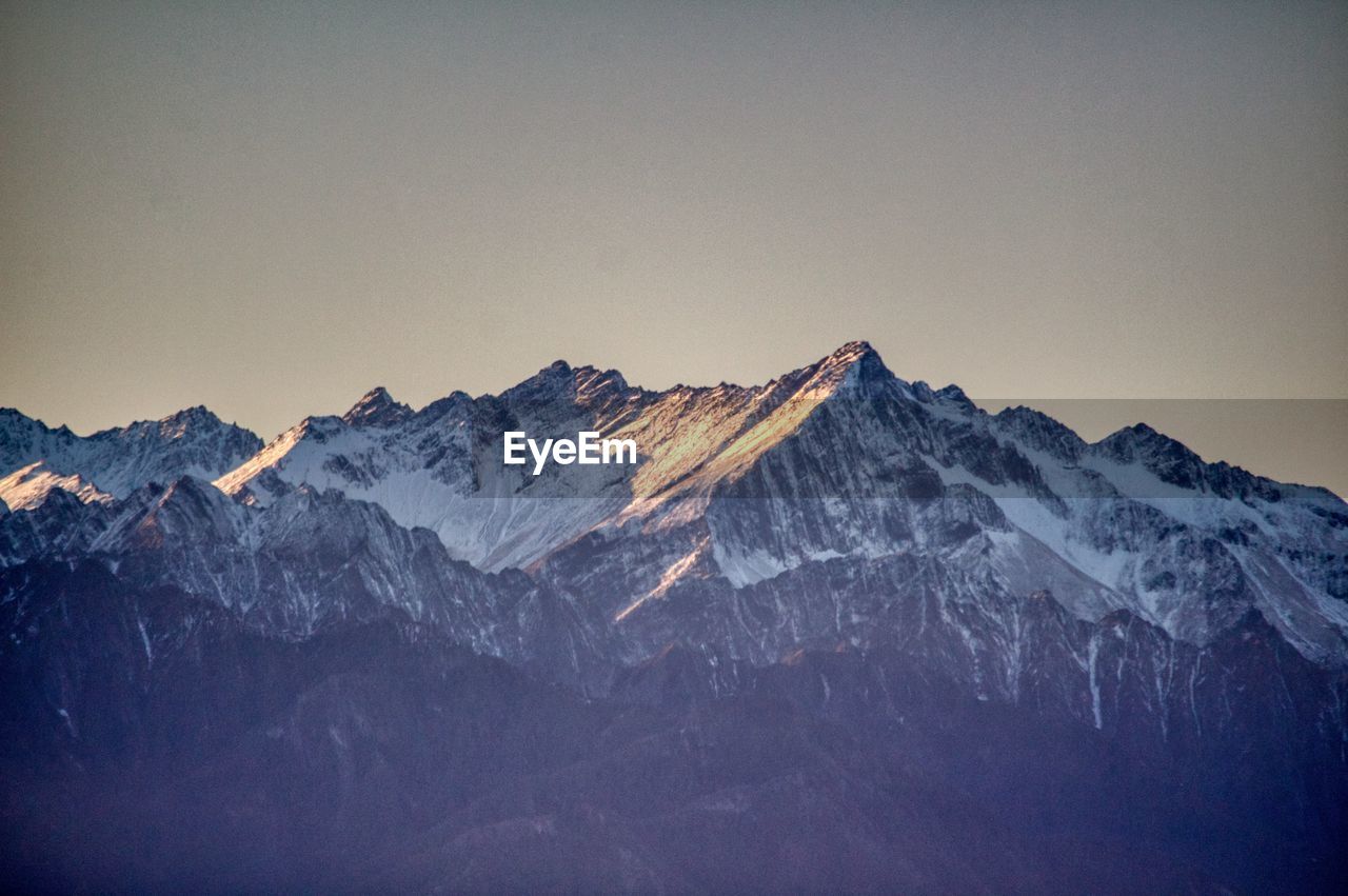 scenic view of snowcapped mountains against sky during sunset