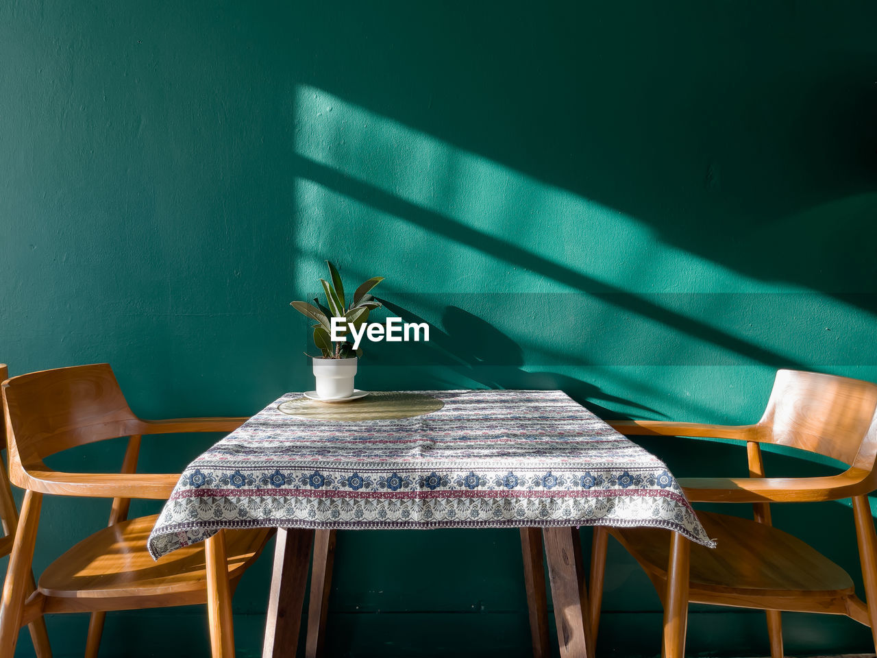 Empty chairs and table against wall at home