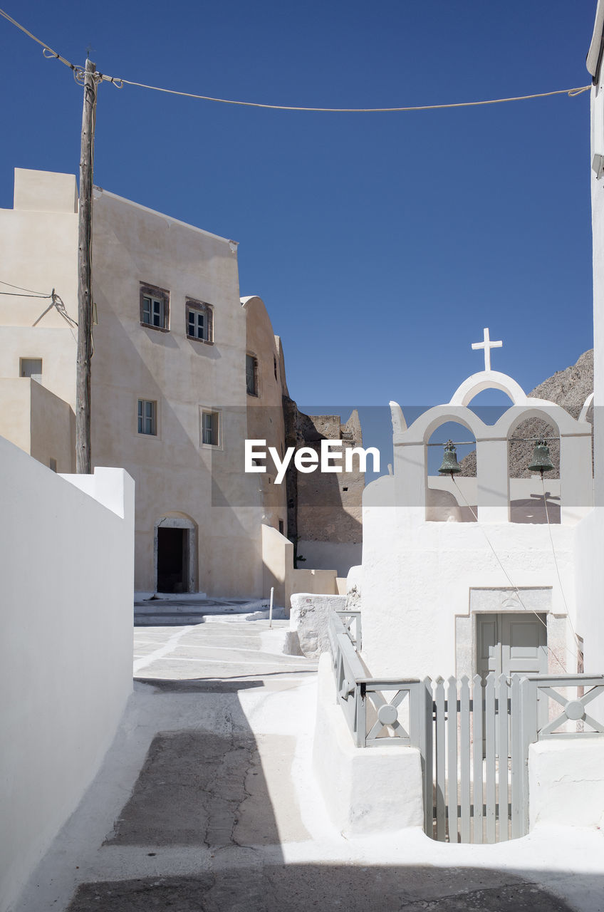 White buildings in town against blue sky