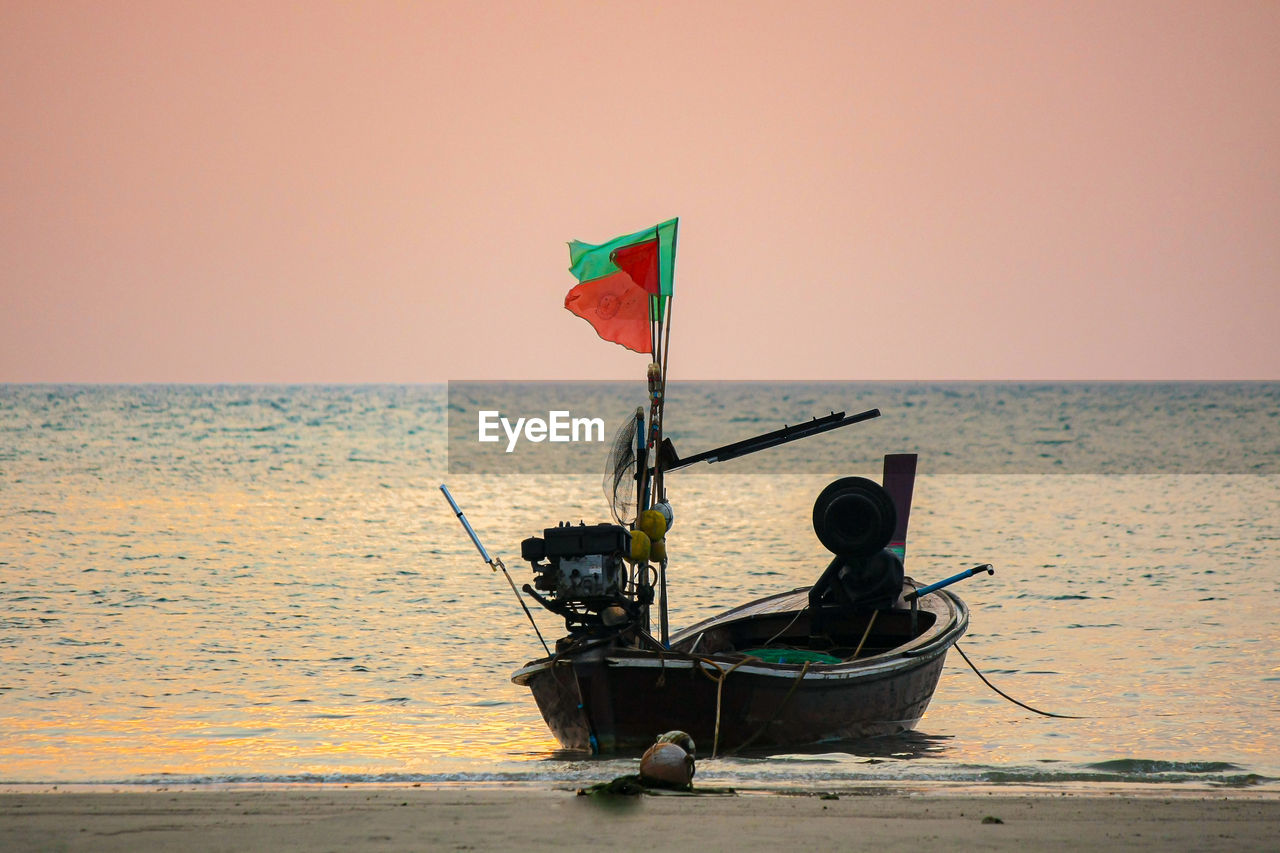 Boat on sea against clear sky