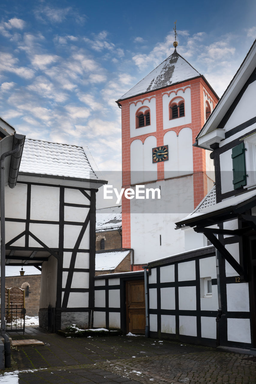 Center of village odenthal with parish church and old buildings on a winter day, germany