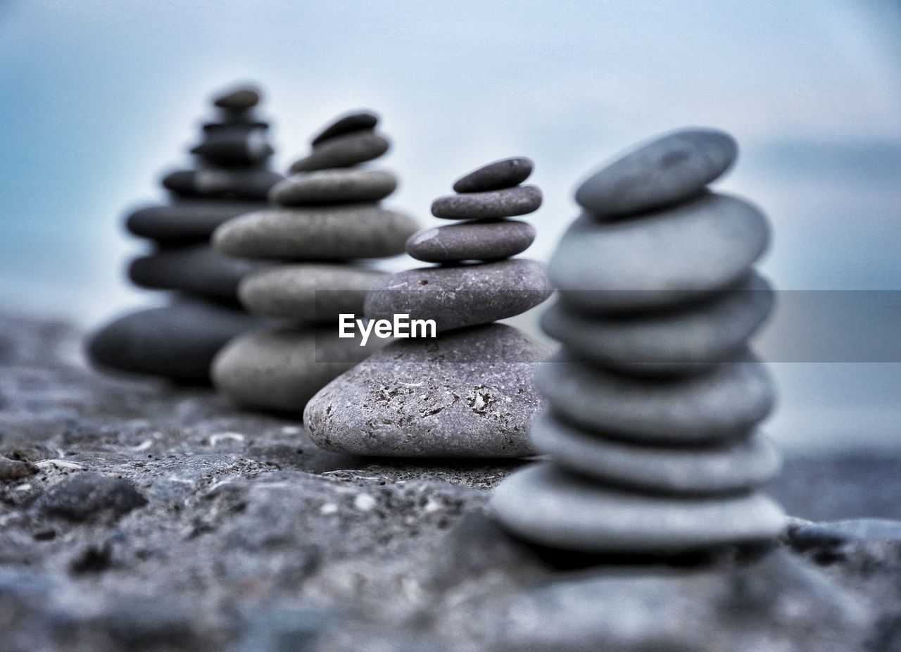 CLOSE-UP OF STACK OF PEBBLES ON ROCKS