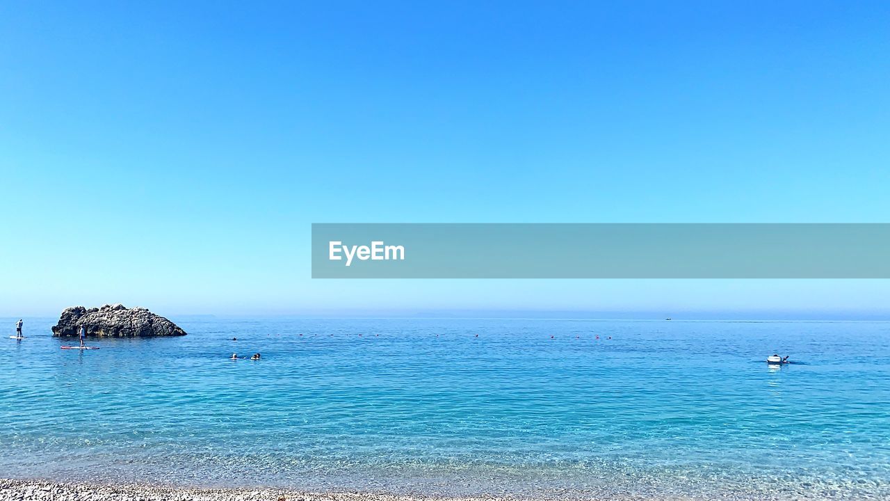 Scenic view of sea against clear blue sky