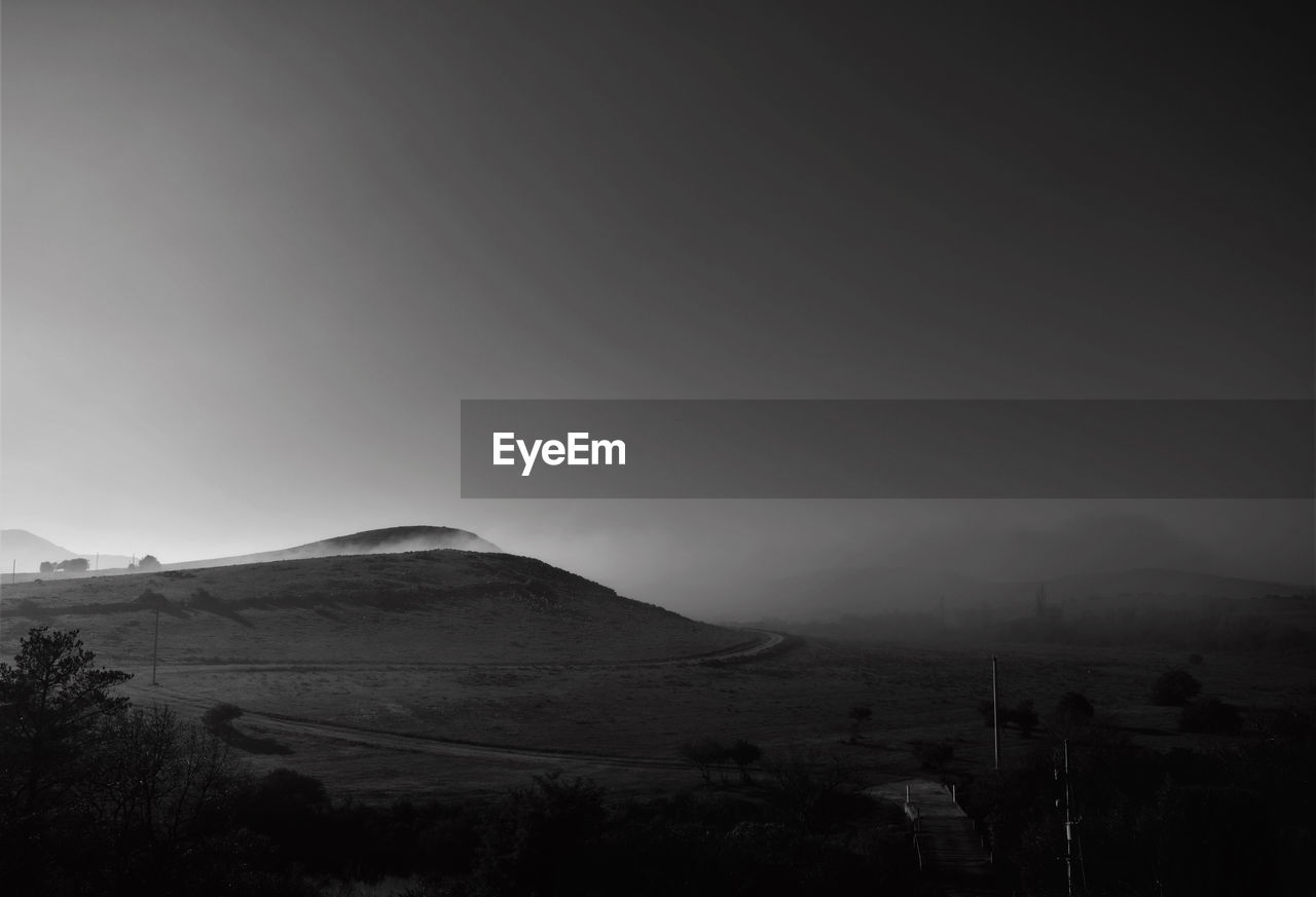 SCENIC VIEW OF LANDSCAPE AND MOUNTAINS AGAINST SKY