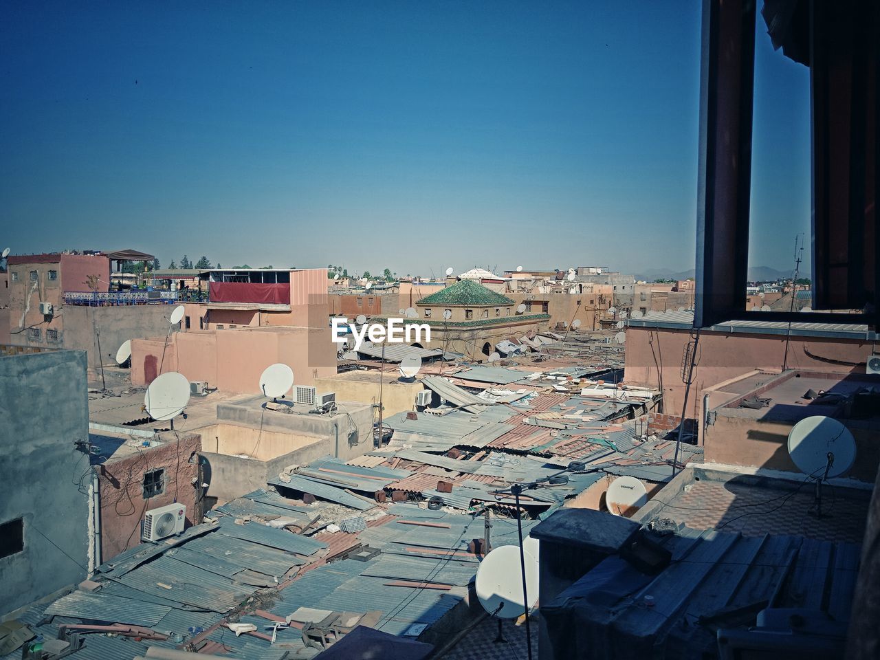 High angle view of buildings against clear blue sky