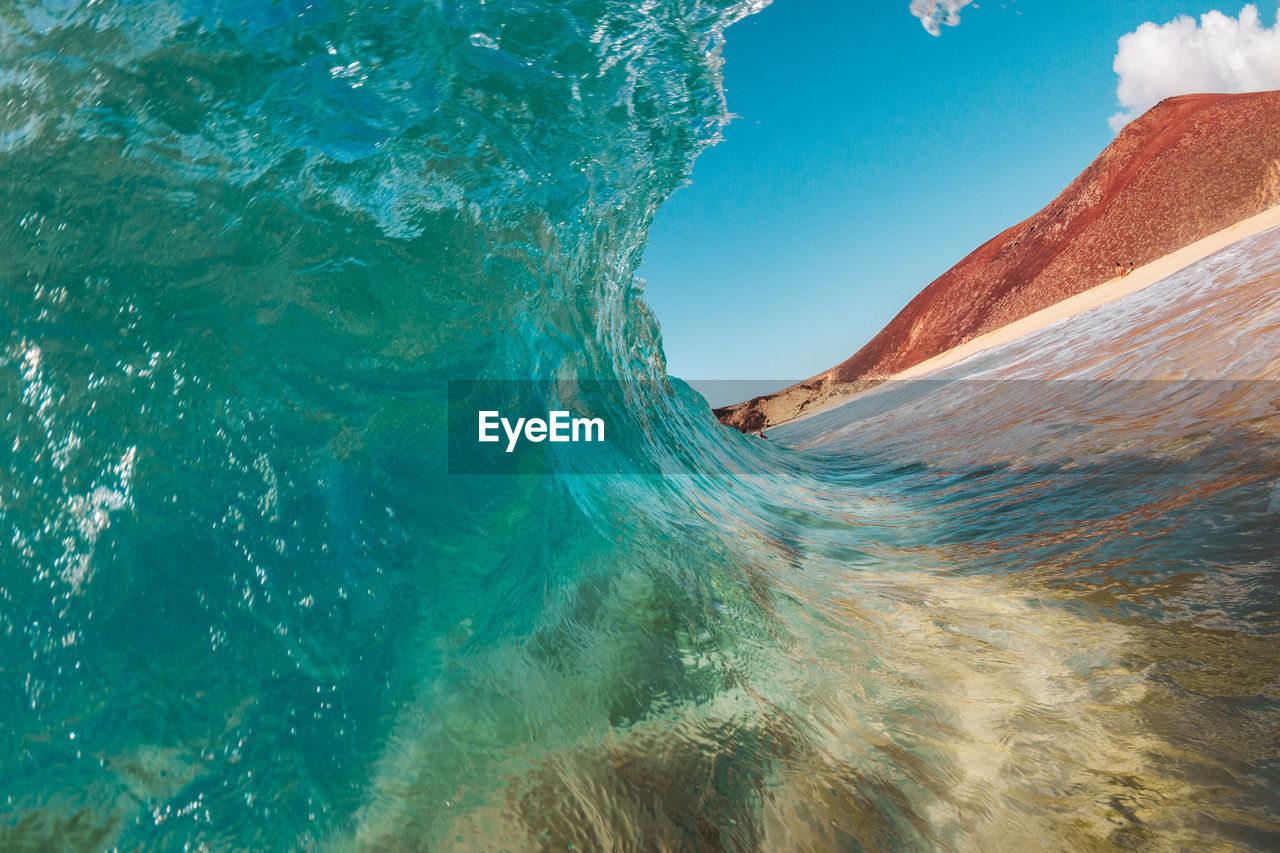 Ocean in sea against blue sky