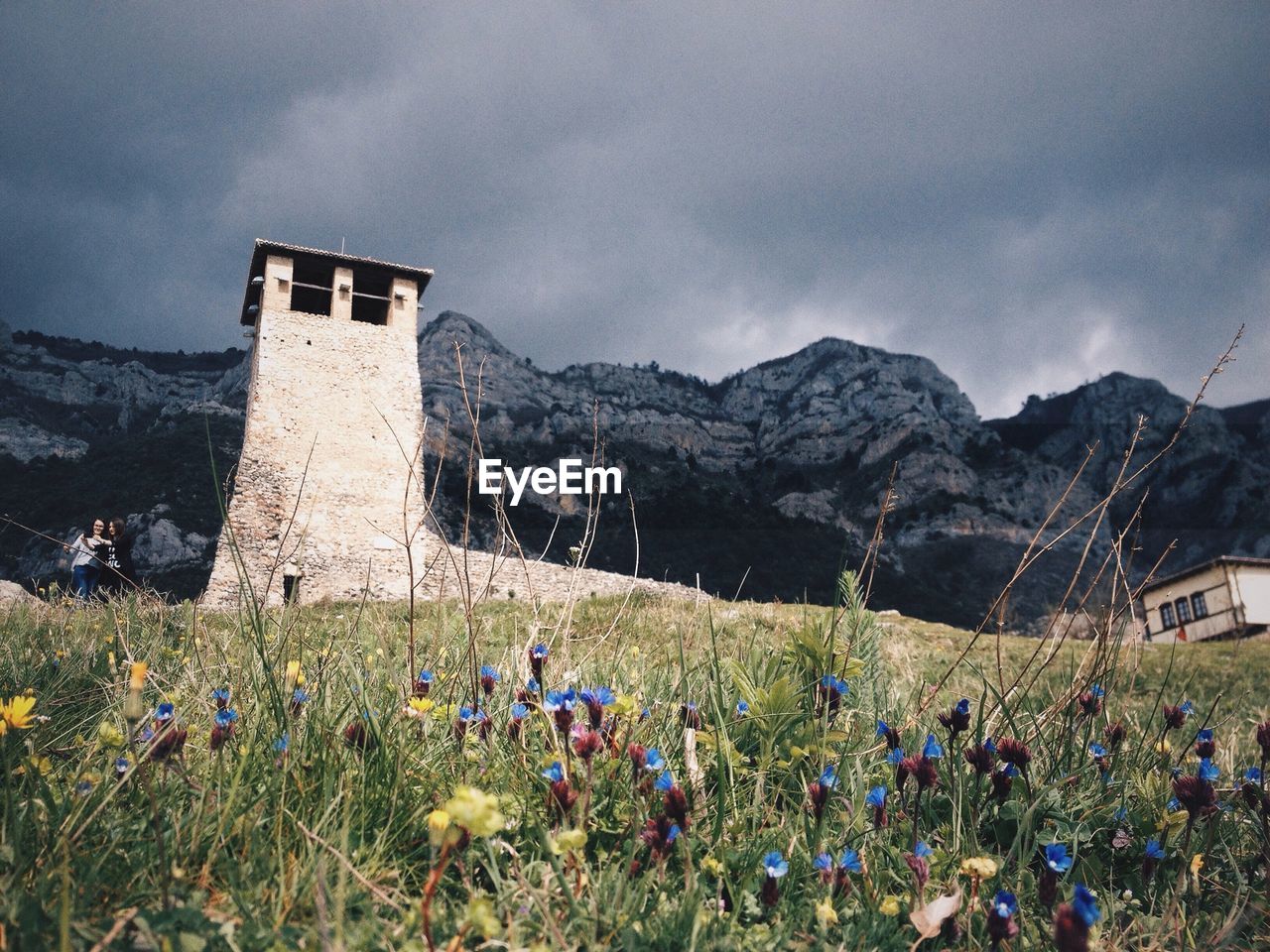 Low angle view of lookout tower against cloudy sky