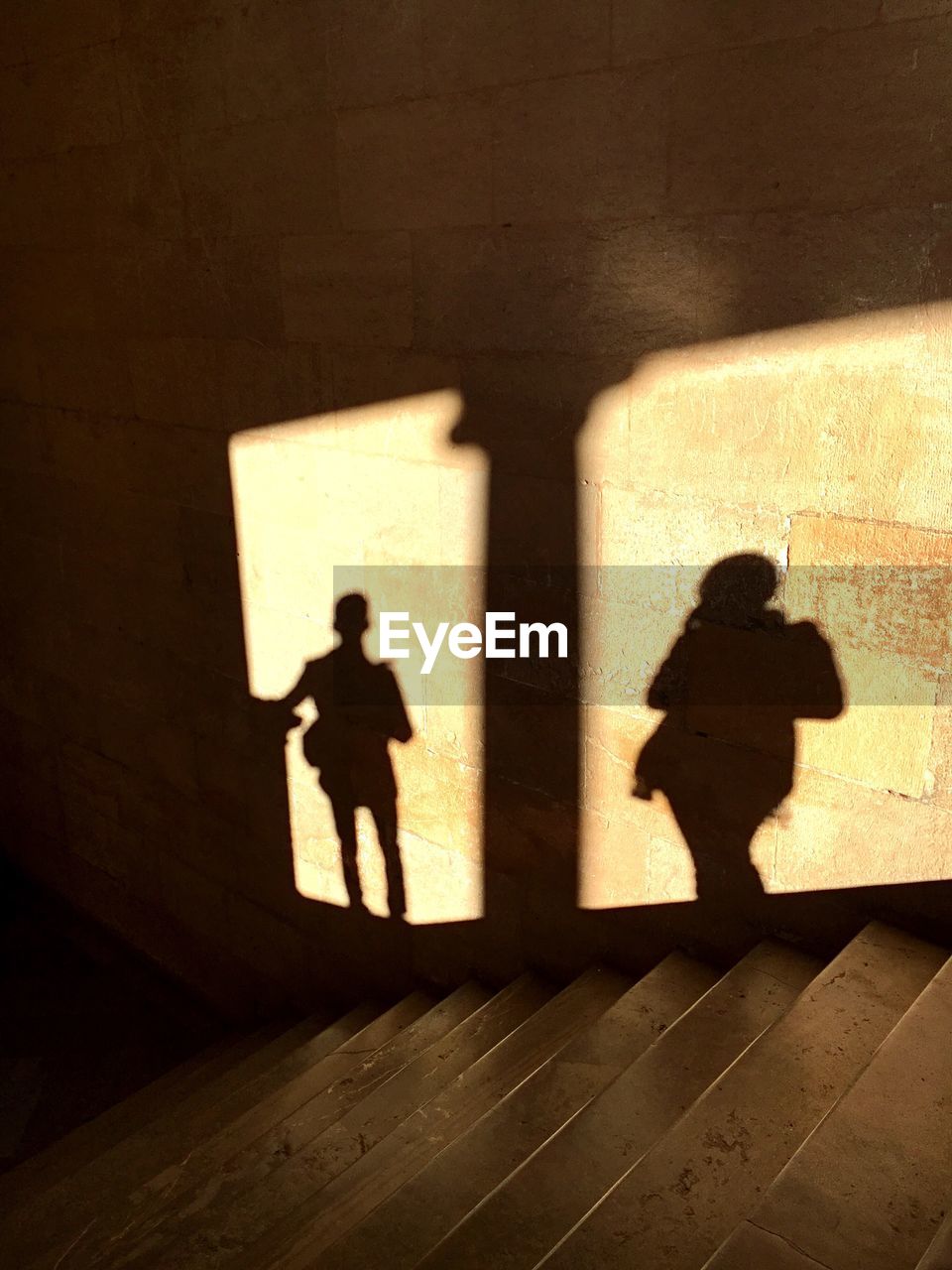 SILHOUETTE MAN STANDING WITH SHADOW ON FLOOR