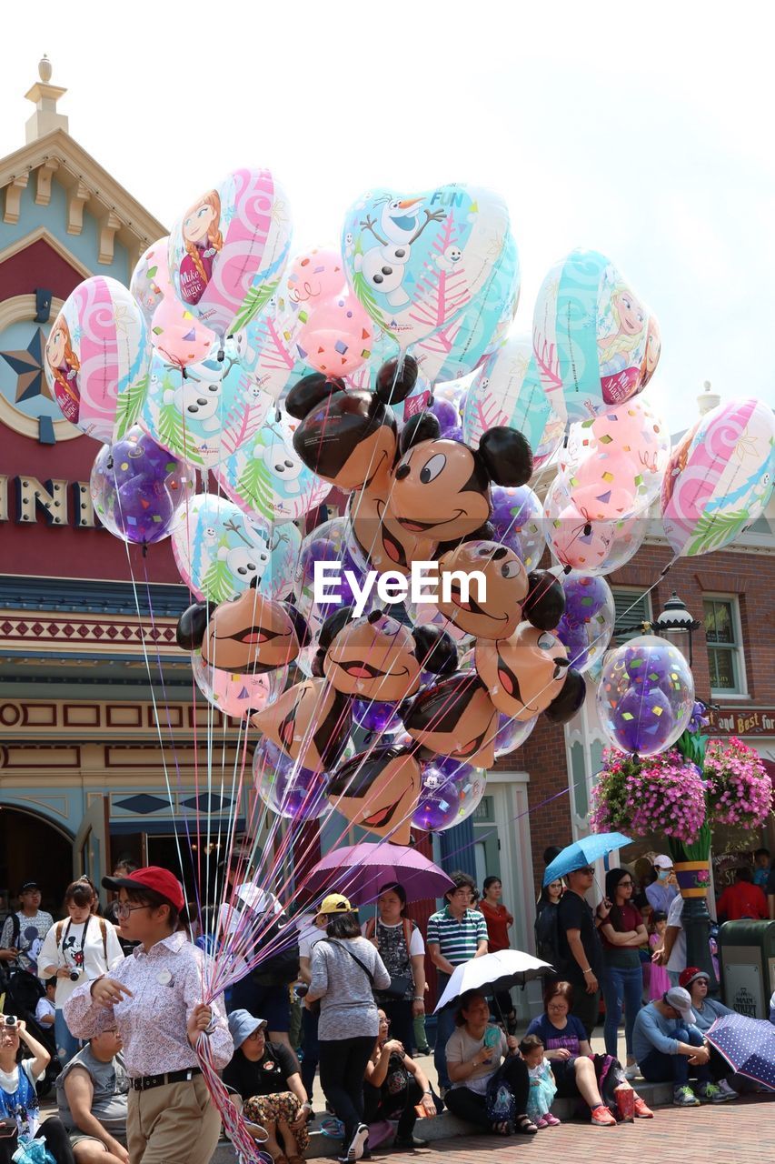 GROUP OF PEOPLE IN AMUSEMENT PARK