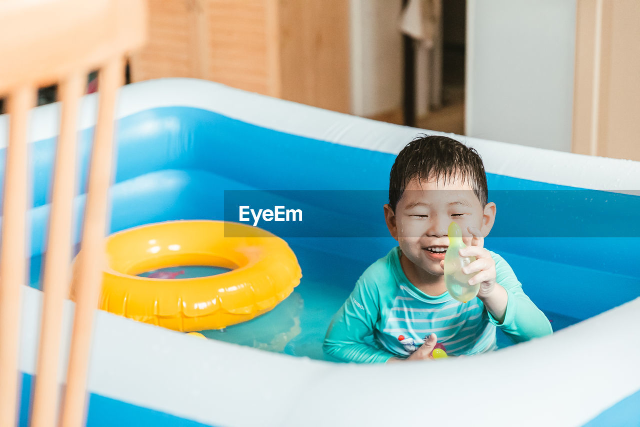 portrait of boy playing with slide