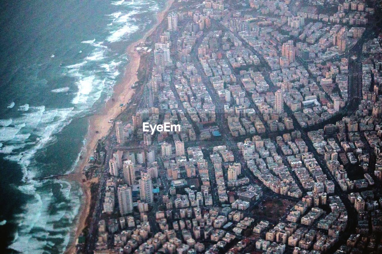 Aerial view of cityscape by sea
