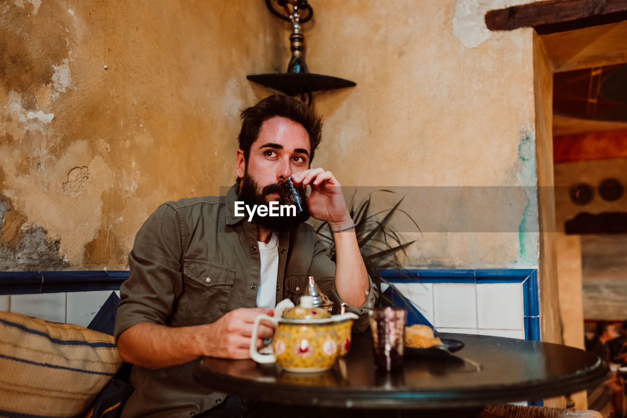 Man having drink on table in restaurant