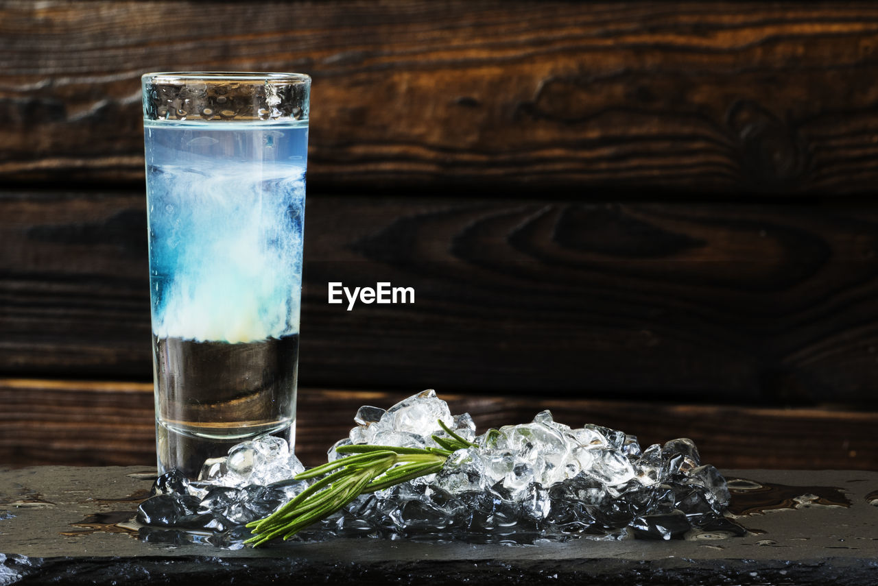 Close-up of cocktail served with ice cubes on slate